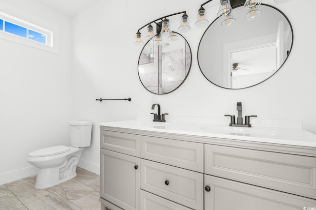 bathroom featuring ceiling fan, toilet, and vanity