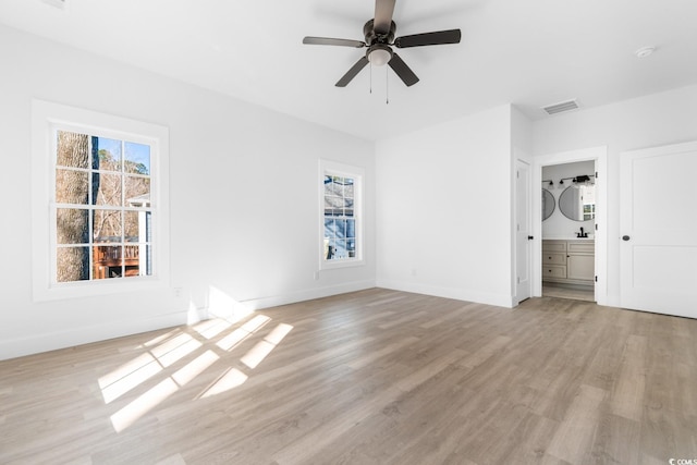 unfurnished bedroom featuring ensuite bathroom, ceiling fan, and light hardwood / wood-style floors