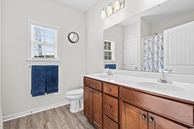 bathroom with vanity, toilet, and wood-type flooring