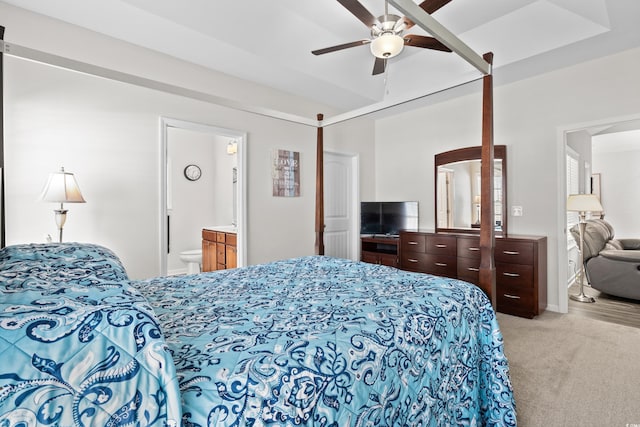 bedroom with connected bathroom, ceiling fan, and light carpet