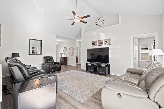 living room featuring hardwood / wood-style floors, high vaulted ceiling, and ceiling fan