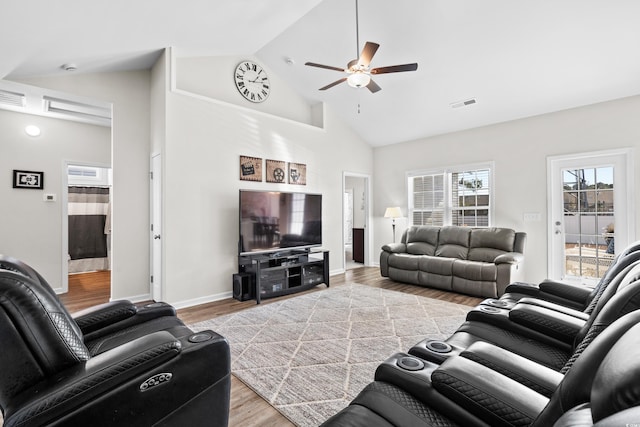 living room with light hardwood / wood-style floors, high vaulted ceiling, and ceiling fan