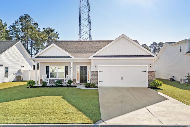 view of front of home with covered porch, a garage, and a front yard