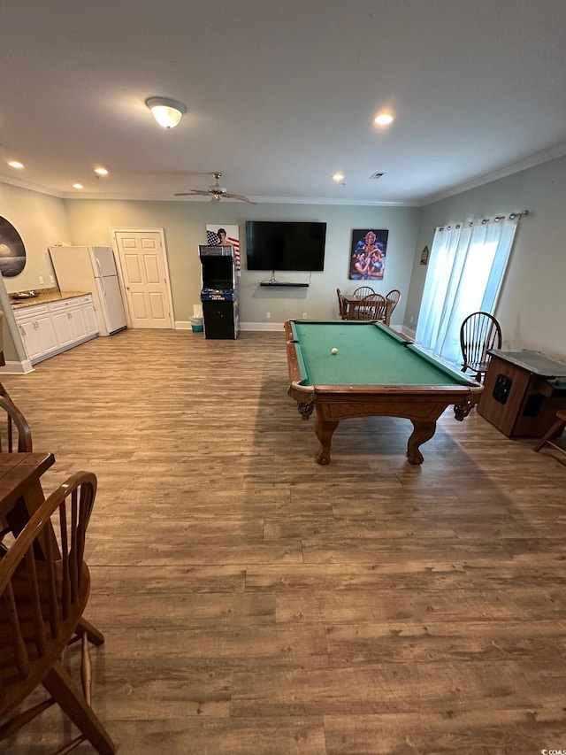 recreation room with hardwood / wood-style flooring, ceiling fan, ornamental molding, and billiards