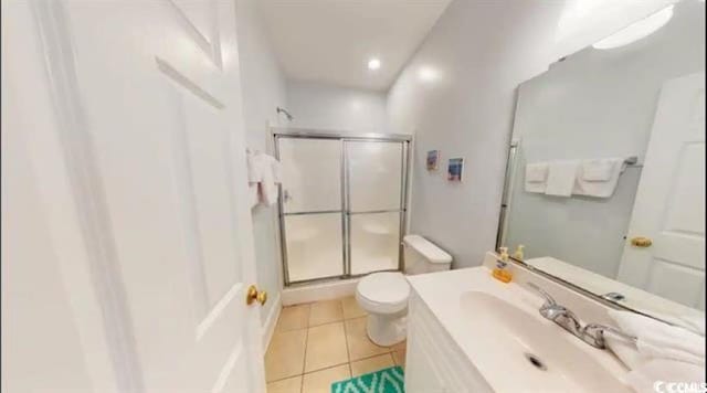 full bathroom with vanity, a shower stall, toilet, and tile patterned floors