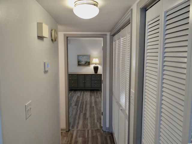 hallway with dark hardwood / wood-style floors