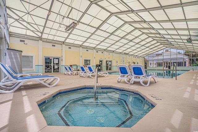 view of pool with an indoor hot tub and a lanai