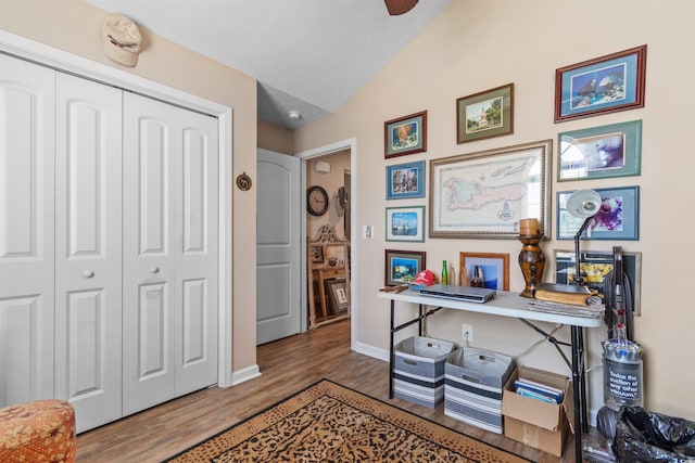 office area with hardwood / wood-style floors and vaulted ceiling