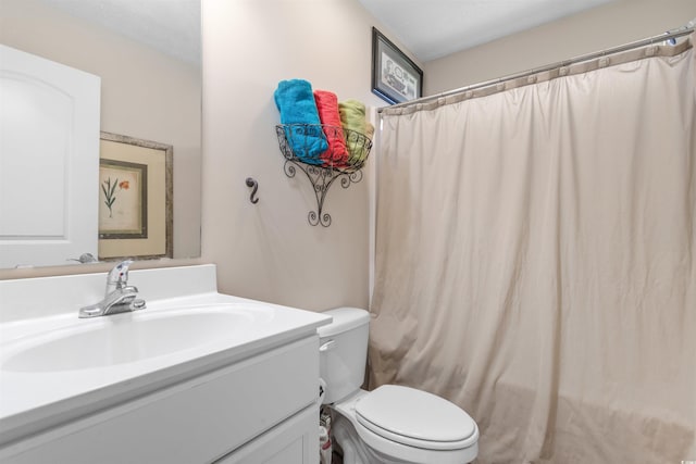 bathroom featuring vanity, a shower with curtain, and toilet