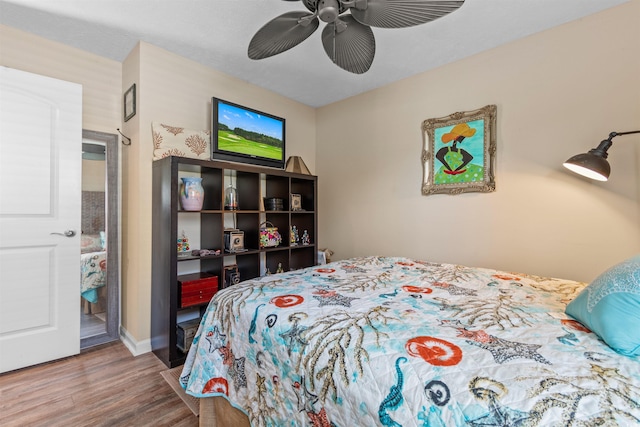 bedroom with wood-type flooring and ceiling fan