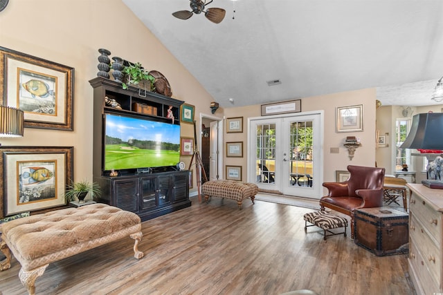 living room with lofted ceiling, wood-type flooring, french doors, and ceiling fan