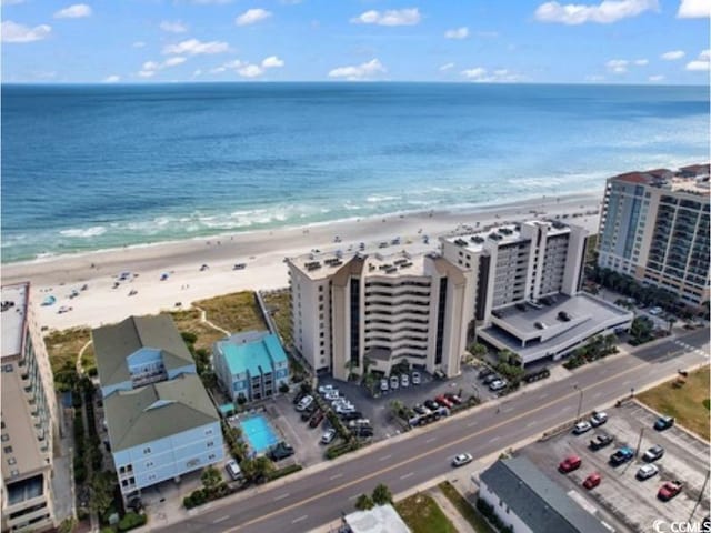 drone / aerial view featuring a water view and a beach view