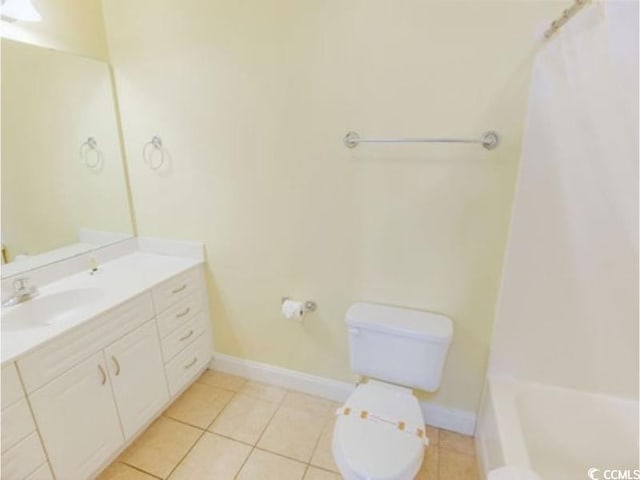 full bath with vanity, tile patterned flooring, toilet, and baseboards