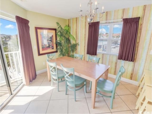 dining area with a chandelier, a wealth of natural light, light tile patterned flooring, and baseboards