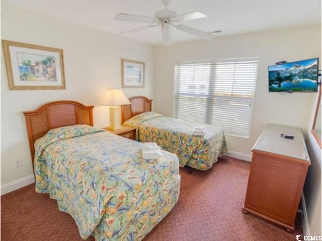 carpeted bedroom featuring a ceiling fan and baseboards