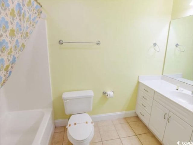 bathroom with toilet, tile patterned floors, vanity, baseboards, and shower / tub combo with curtain