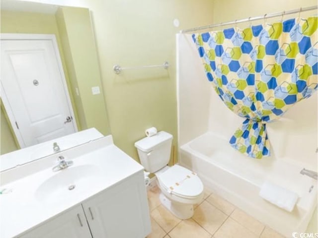 full bath featuring vanity, shower / bath combo with shower curtain, tile patterned flooring, and toilet