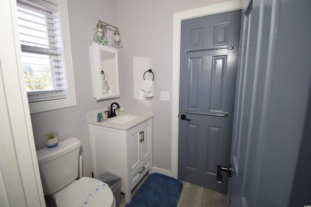 bathroom featuring hardwood / wood-style flooring, vanity, and toilet