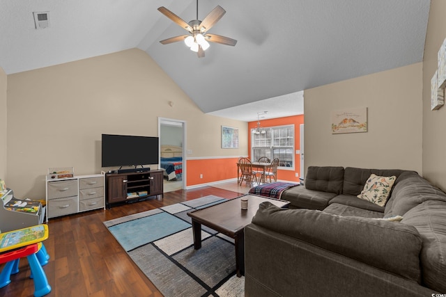 living room featuring vaulted ceiling, ceiling fan, and dark wood-type flooring