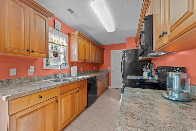 kitchen with black appliances, light tile patterned floors, sink, and a textured ceiling