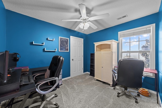 office space with carpet, a textured ceiling, and ceiling fan