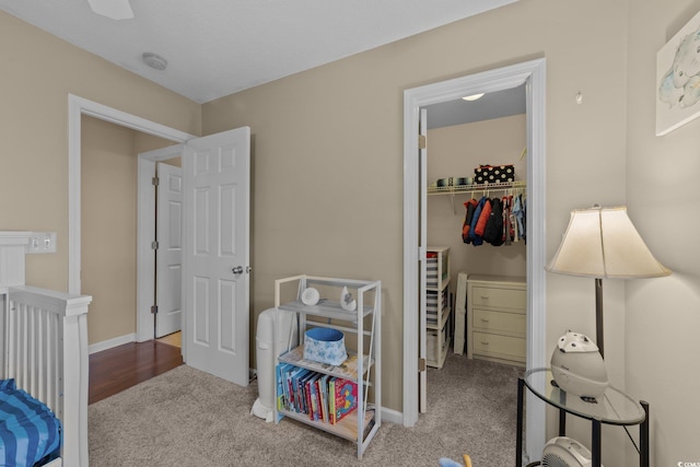 bedroom featuring light colored carpet, a closet, and ceiling fan