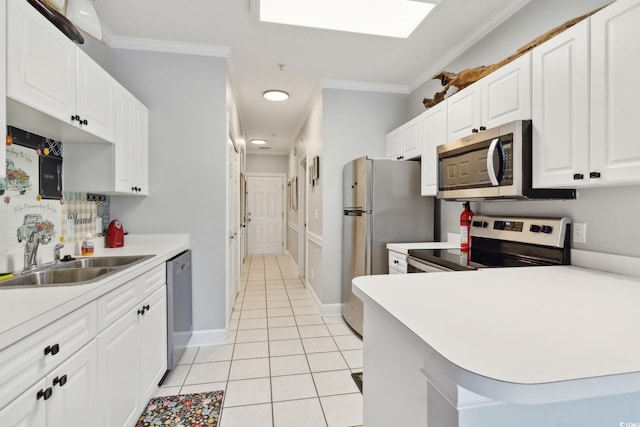 kitchen with crown molding, sink, white cabinets, and stainless steel appliances