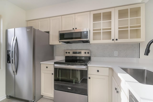 kitchen with backsplash, sink, and stainless steel appliances