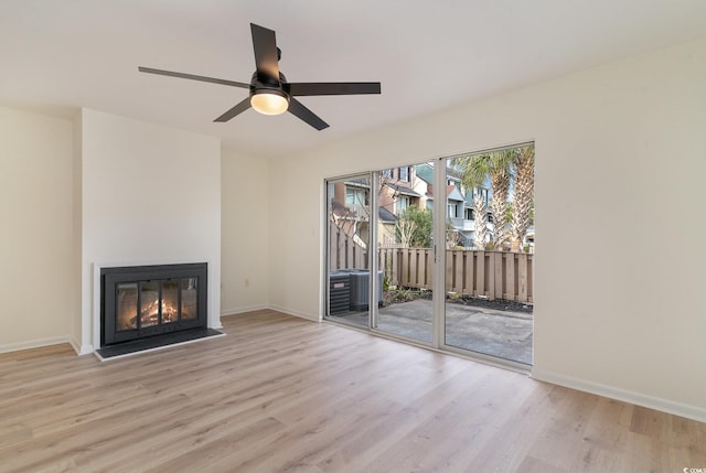 unfurnished living room with light hardwood / wood-style flooring and ceiling fan