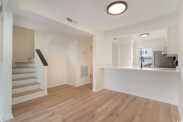 interior space with light hardwood / wood-style flooring and sink