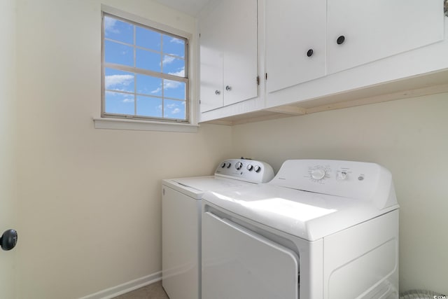 laundry room with cabinets and washing machine and clothes dryer