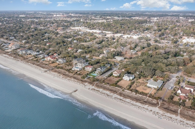 drone / aerial view featuring a water view and a view of the beach