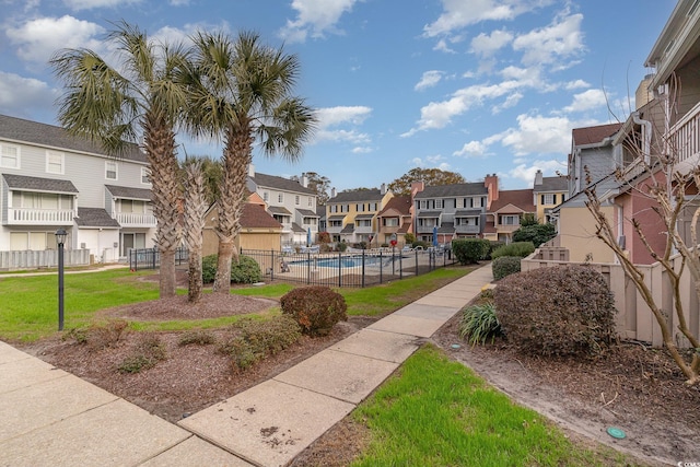 view of home's community with a lawn and a swimming pool