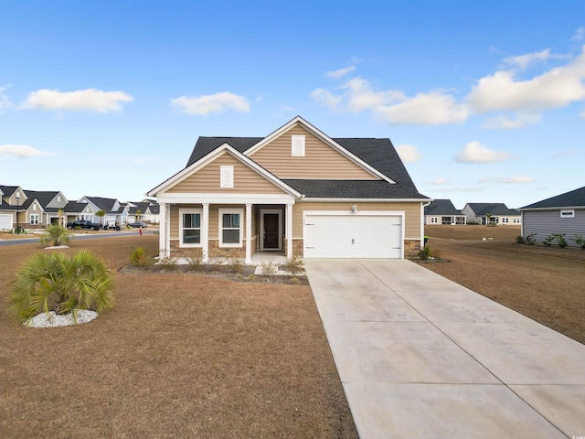 view of front facade featuring a shingled roof, a residential view, concrete driveway, a garage, and stone siding