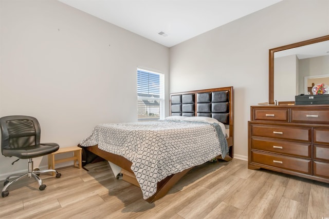 bedroom featuring visible vents, baseboards, and light wood-style flooring