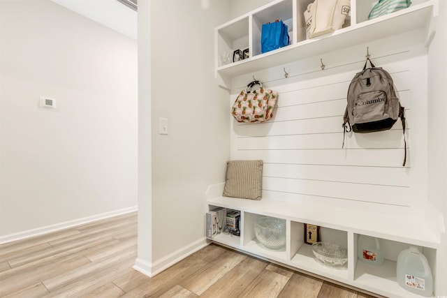 mudroom featuring baseboards and light wood-type flooring