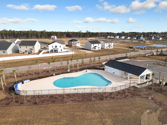 pool featuring fence and a residential view