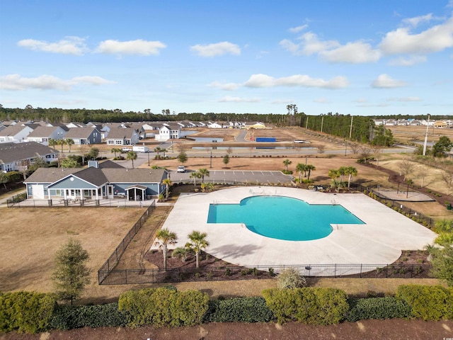 pool with a patio area, a residential view, and fence private yard