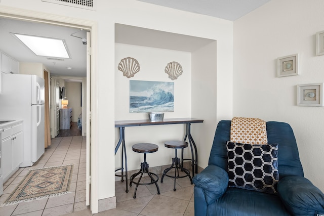 living area featuring light tile patterned flooring