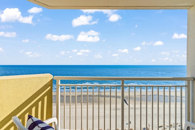 balcony with a beach view and a water view