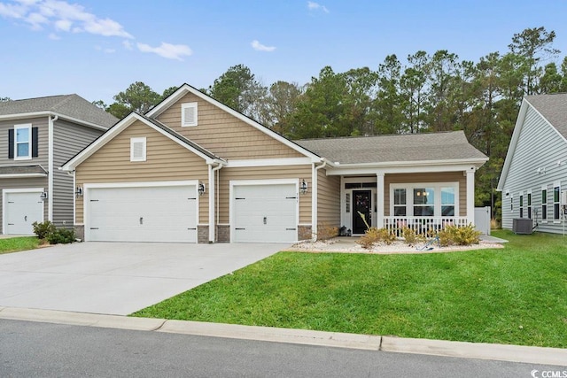 view of front of property with central AC, a garage, a porch, and a front yard