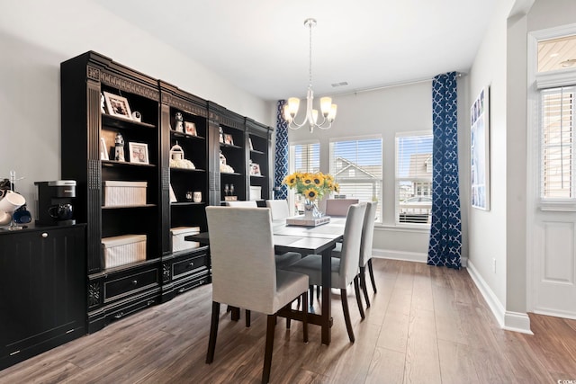 dining area featuring a chandelier and hardwood / wood-style flooring