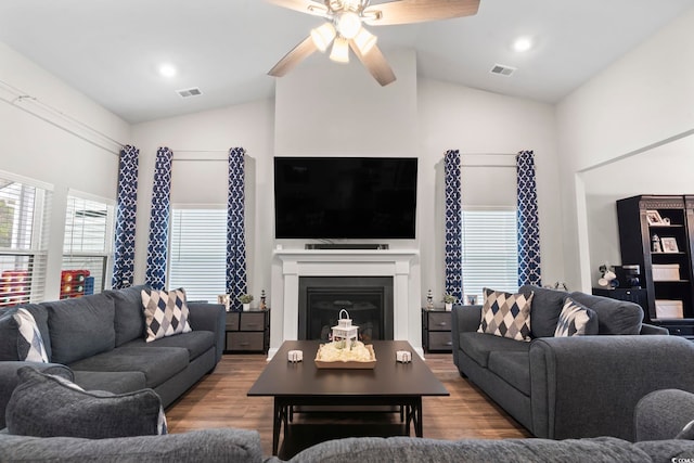 living room featuring ceiling fan, light hardwood / wood-style floors, and lofted ceiling