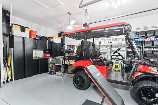 garage with a garage door opener and stainless steel refrigerator