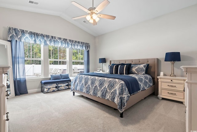 carpeted bedroom with vaulted ceiling and ceiling fan