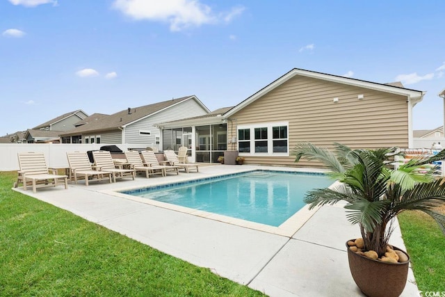 view of swimming pool featuring a sunroom and a patio area