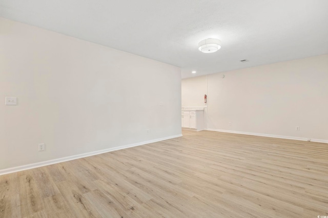 empty room with light hardwood / wood-style flooring