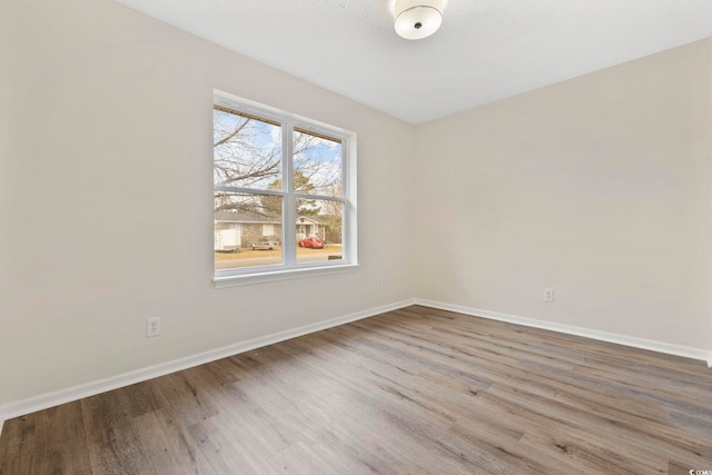 unfurnished room with wood-type flooring