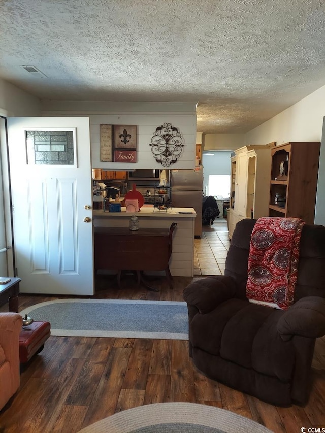 living room featuring hardwood / wood-style floors and a textured ceiling