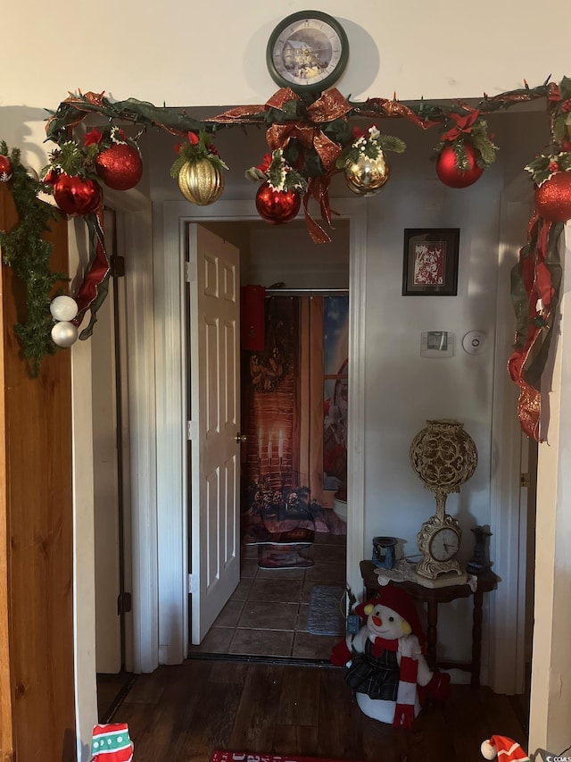 corridor with dark hardwood / wood-style flooring